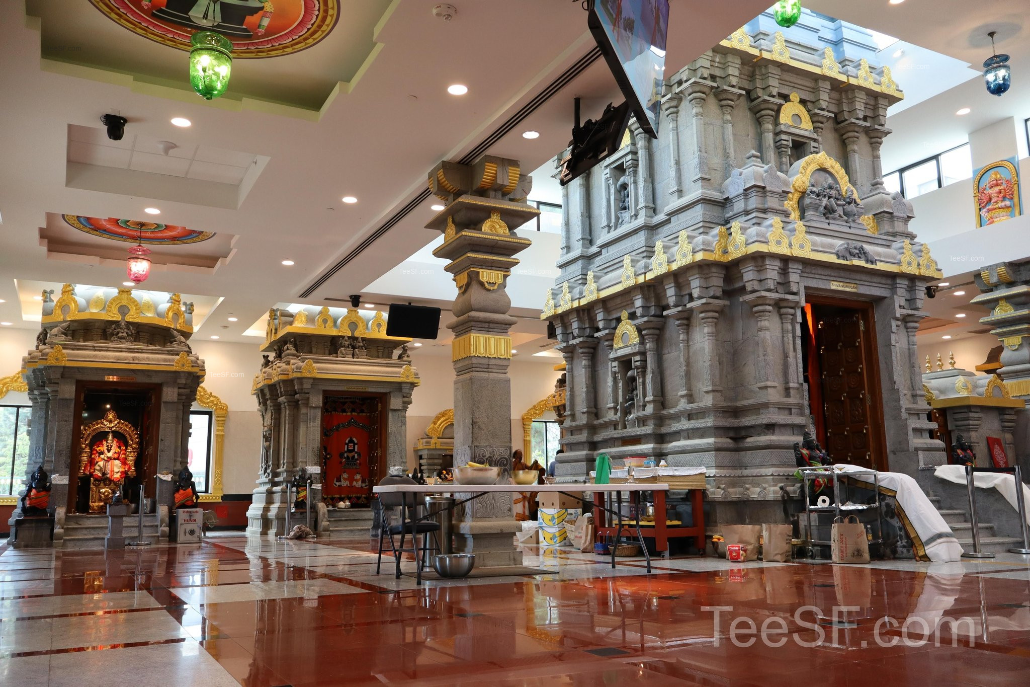 A wide interior view with stone columns and warm ceiling lights.